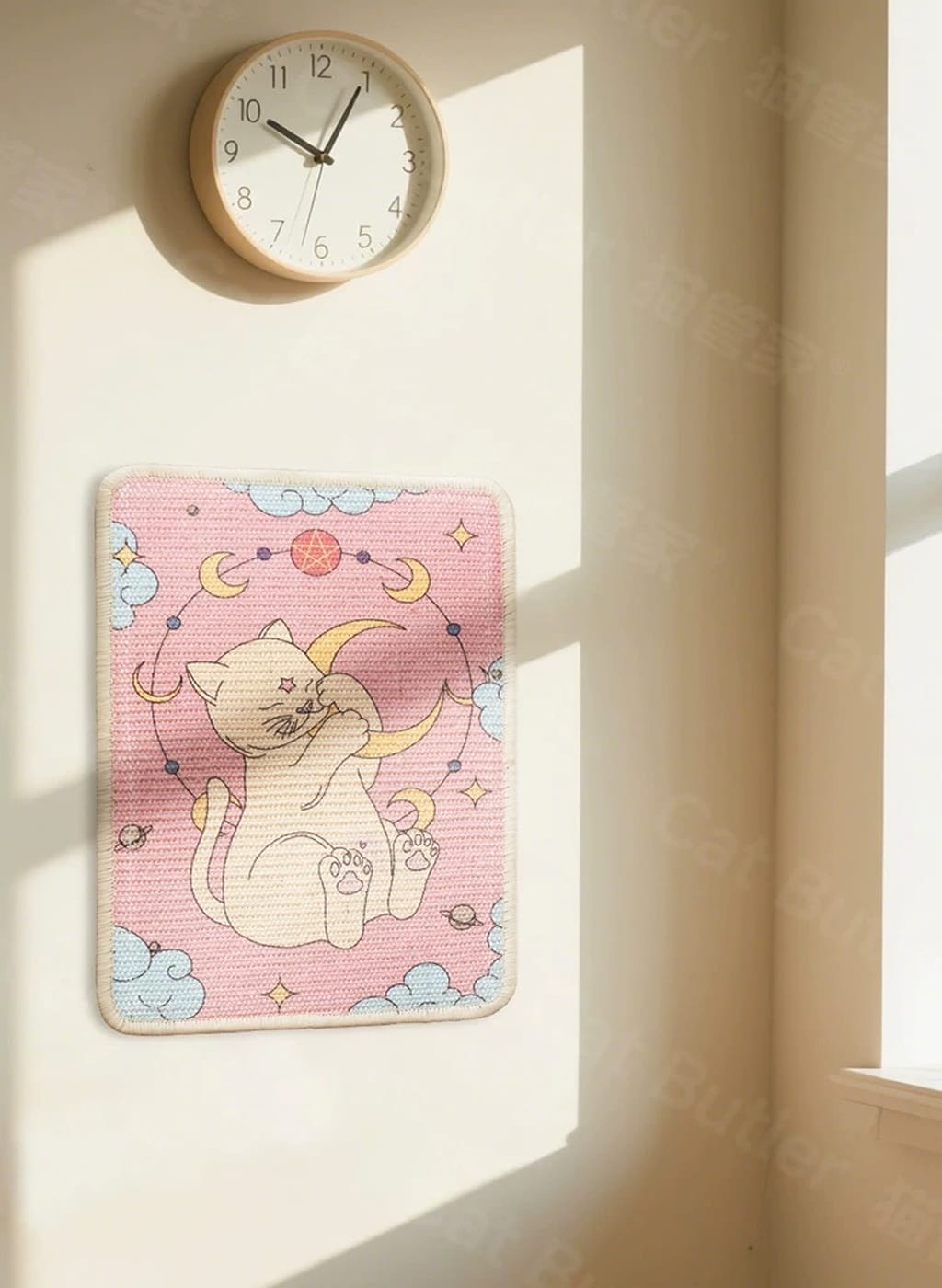 Decorative wall rug with cat design on a light-colored wall next to a clock.